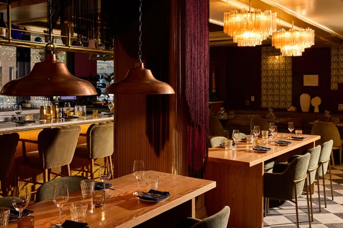 The Mar Bella Wine Bar at Clayton, warmly lit with a long communal table